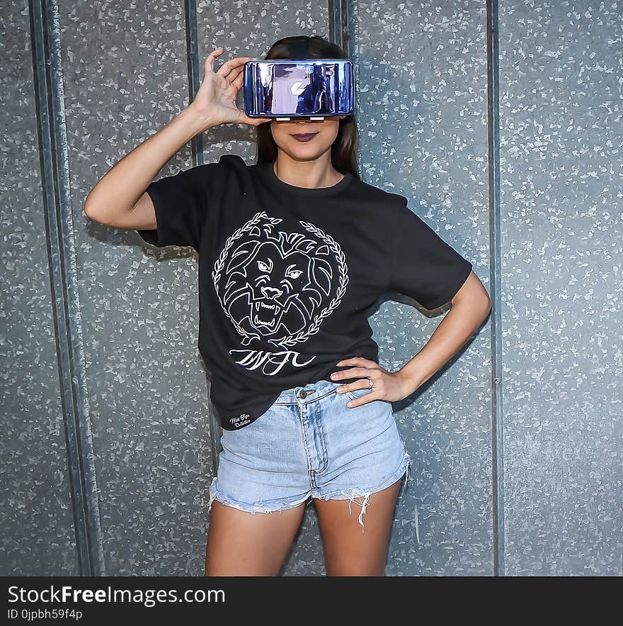 Woman in Black Crew-neck Top Standing Near Wall