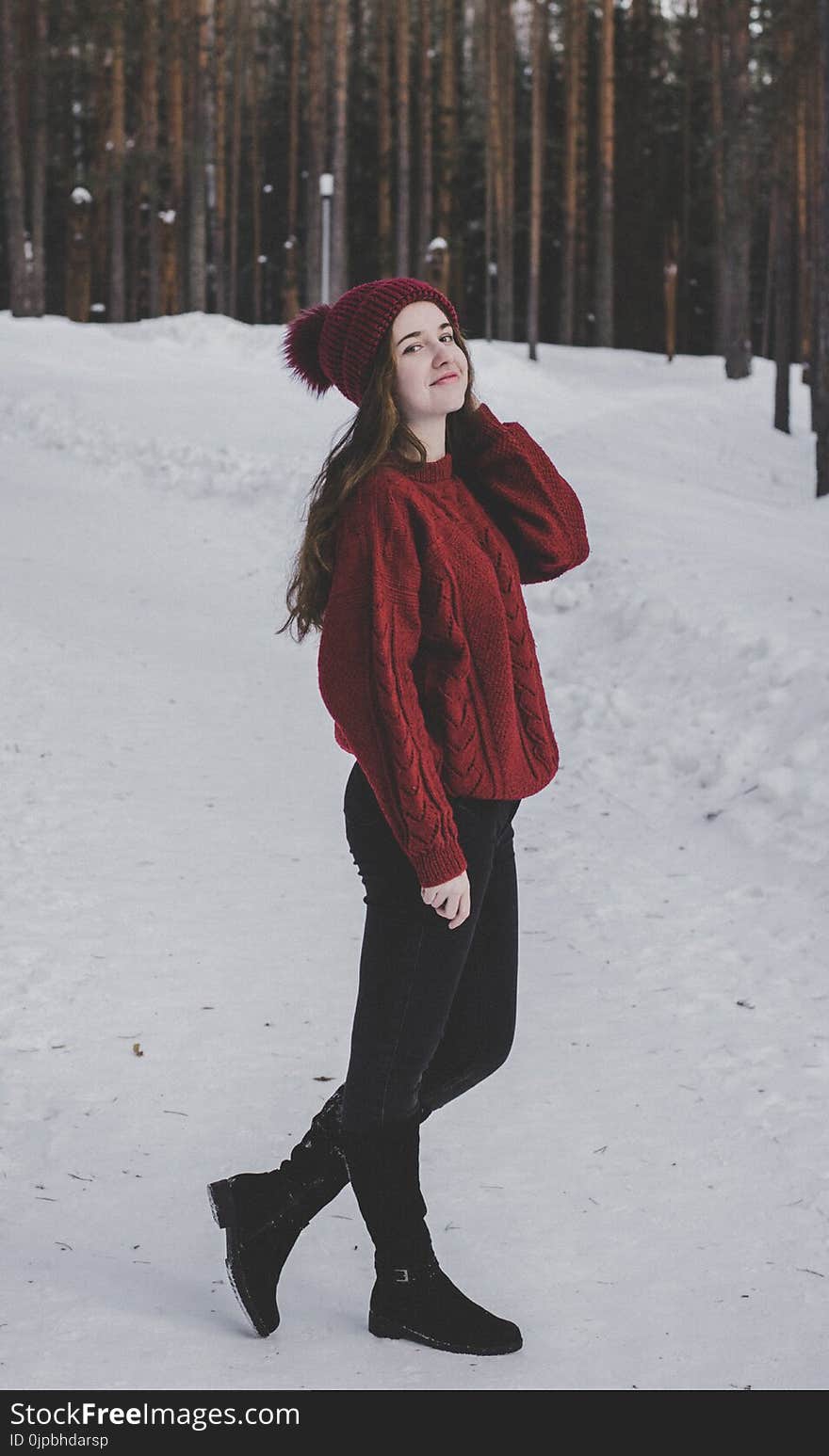 Woman Wearing Knitted Sweater With Hat on Snowfield