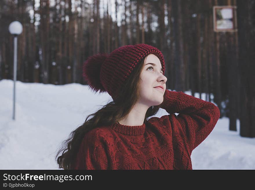 Woman Wearing Maroon Bobble Beanie on Winter Day