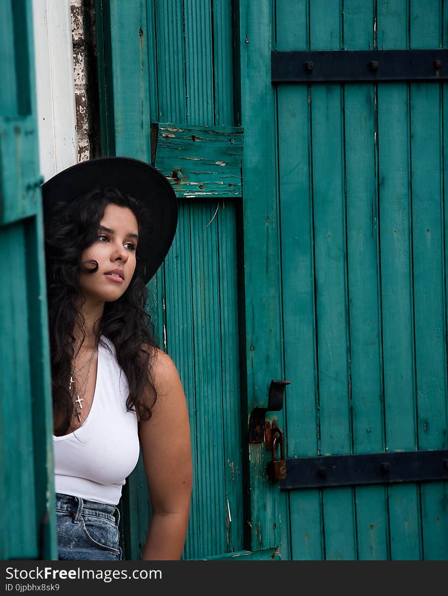 Woman in White Tank Tops and Blue Jeans