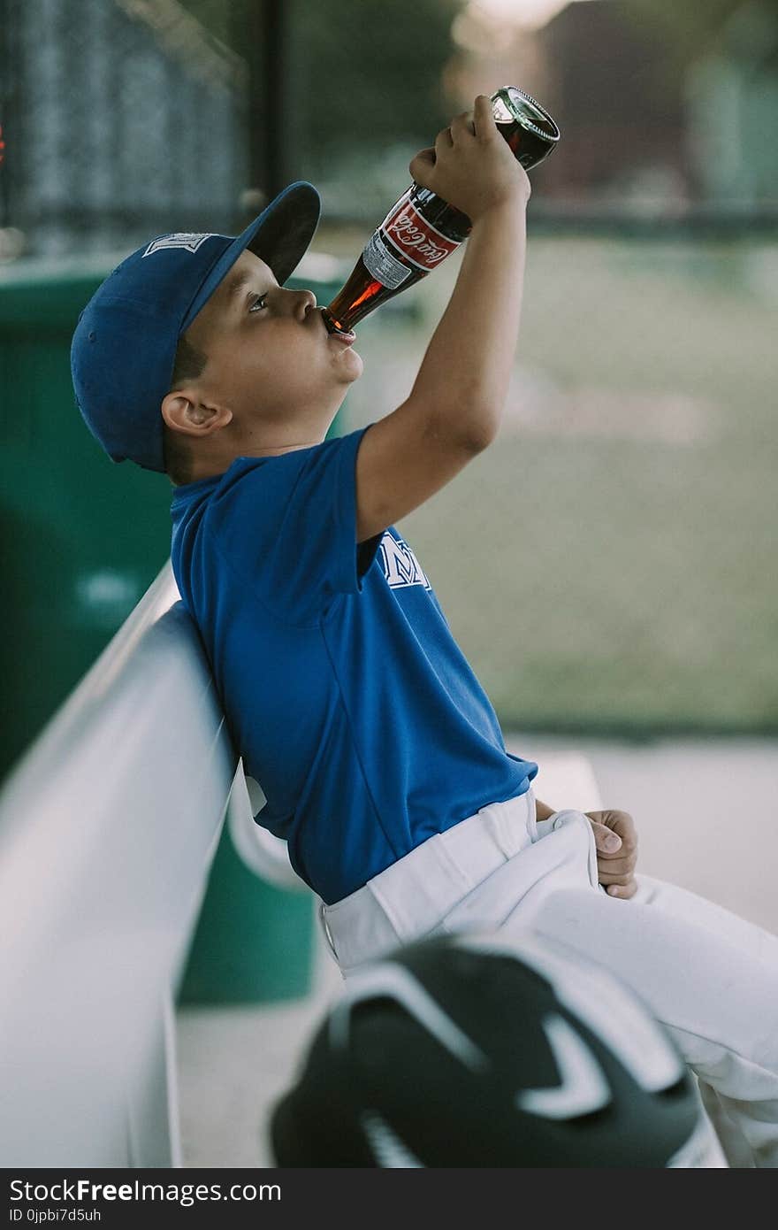 Boy in Blue and White T-shirt Drinking Coca-cola Bottle