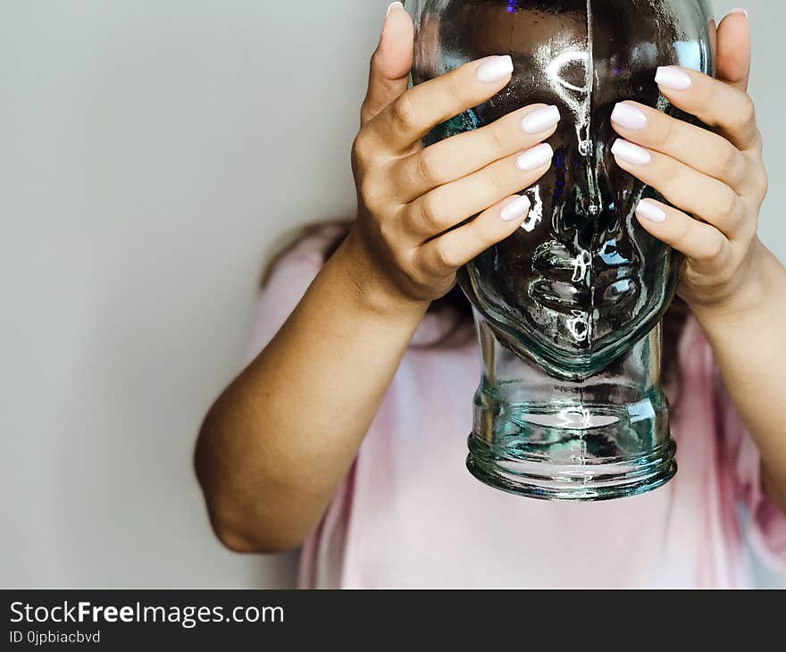 Person Holding Clear Glass Jar