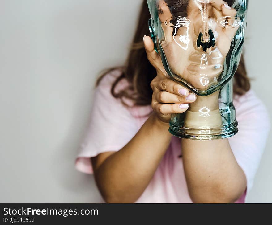 Woman&#x27;s Hand Inside Glass Bottle