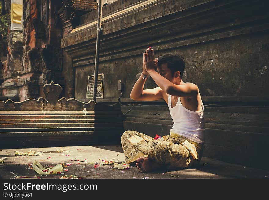 Man Wearing White Tank Top Praying