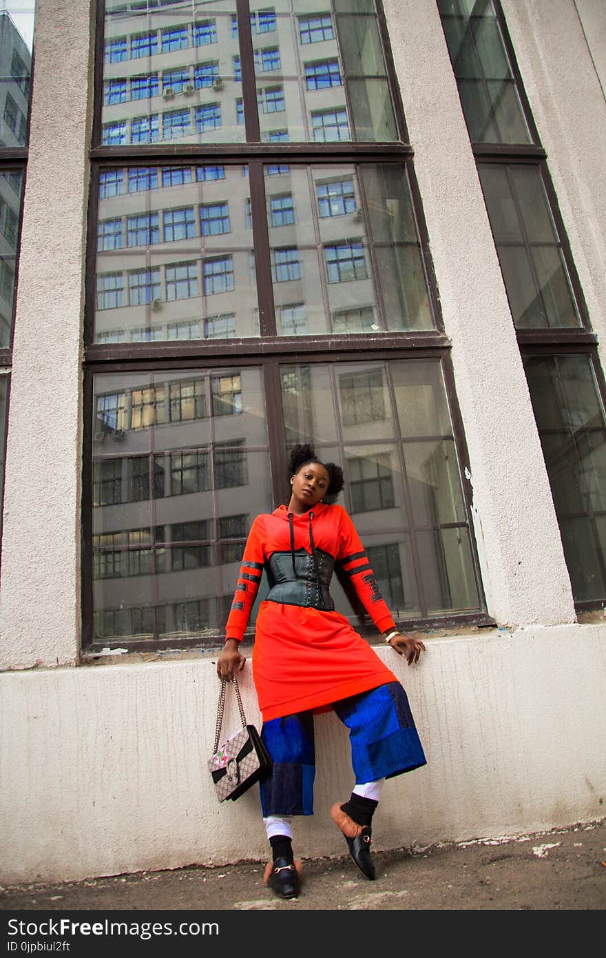 Woman Standing Next to Building