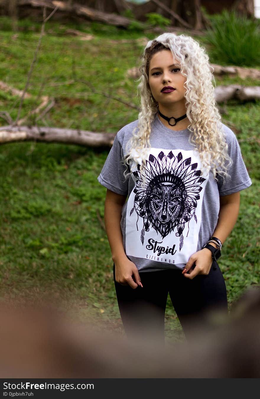 Woman Wearing Gray and Black Tribal Graphic Crew-neck Shirt and Black Pants