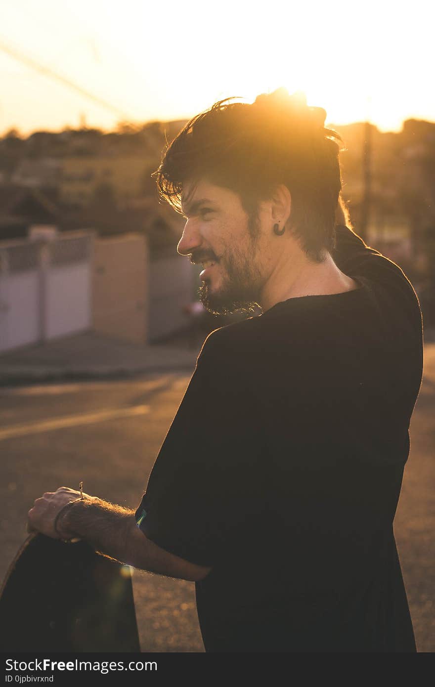 Man Scratching His Head during Sunset