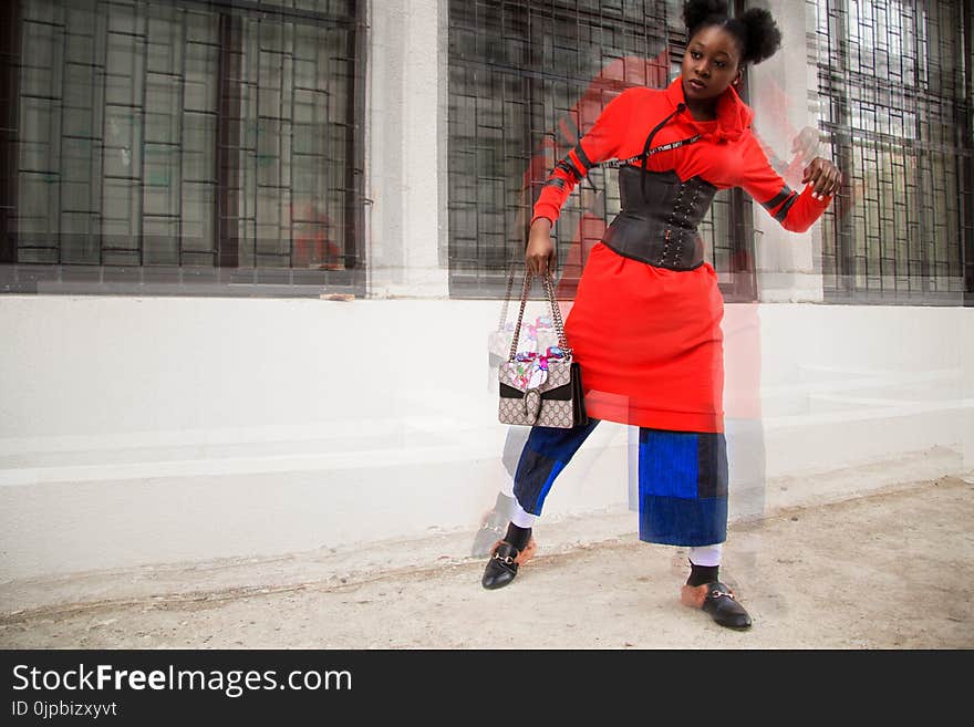 Woman in Red and Multicolored Shirt Dress Holding Bag