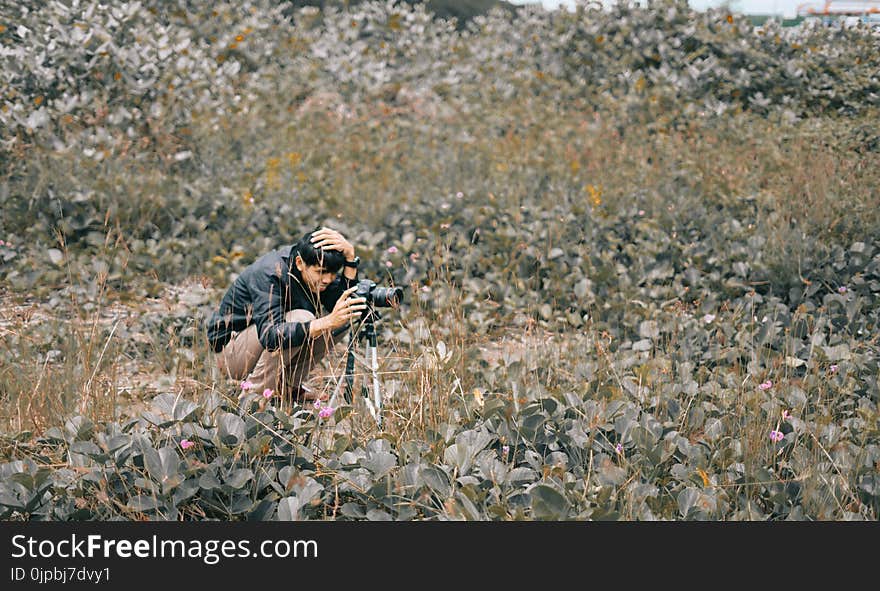 Man Taking Photo Using Dslr Camera