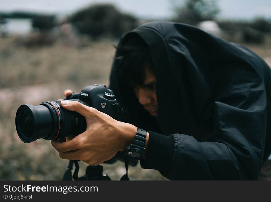 Black Canon Dslr Camera on Hand