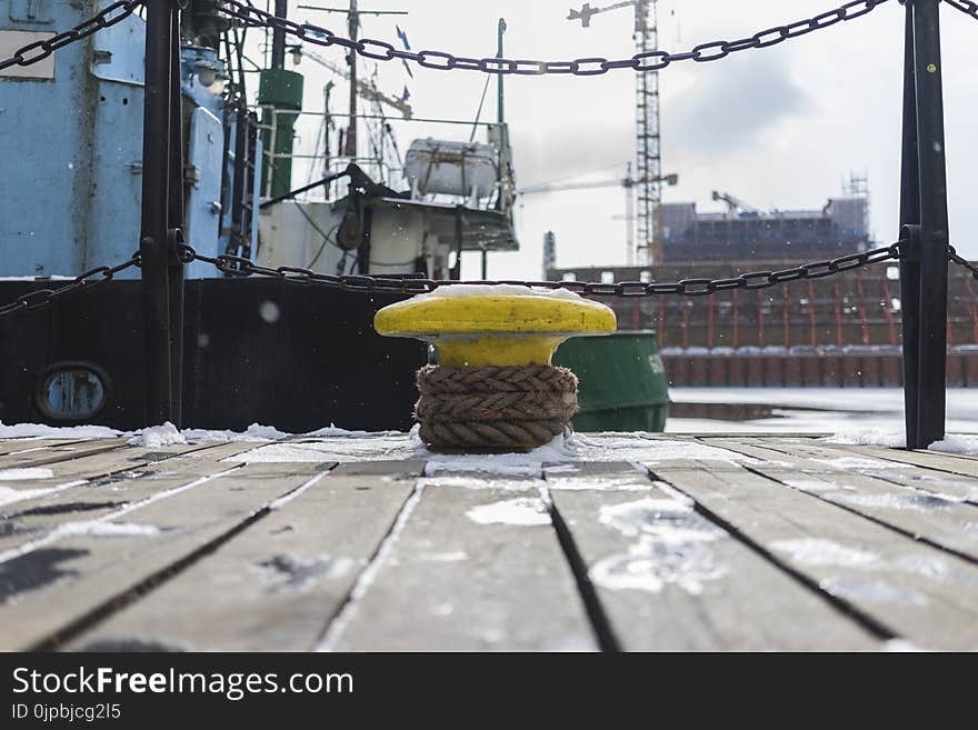 Yellow Anvil Beside Green Boat