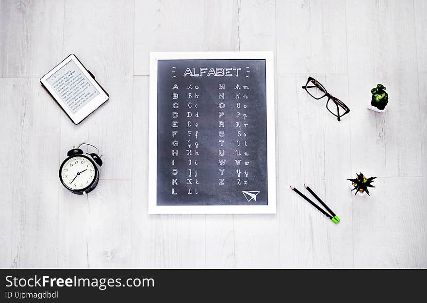 Alphabet Chalkboard at the Center of Assorted Items