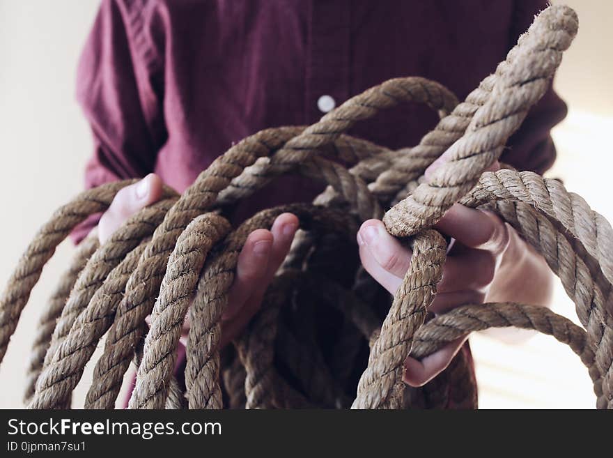 Close-up Photography of Man Holding a Rope