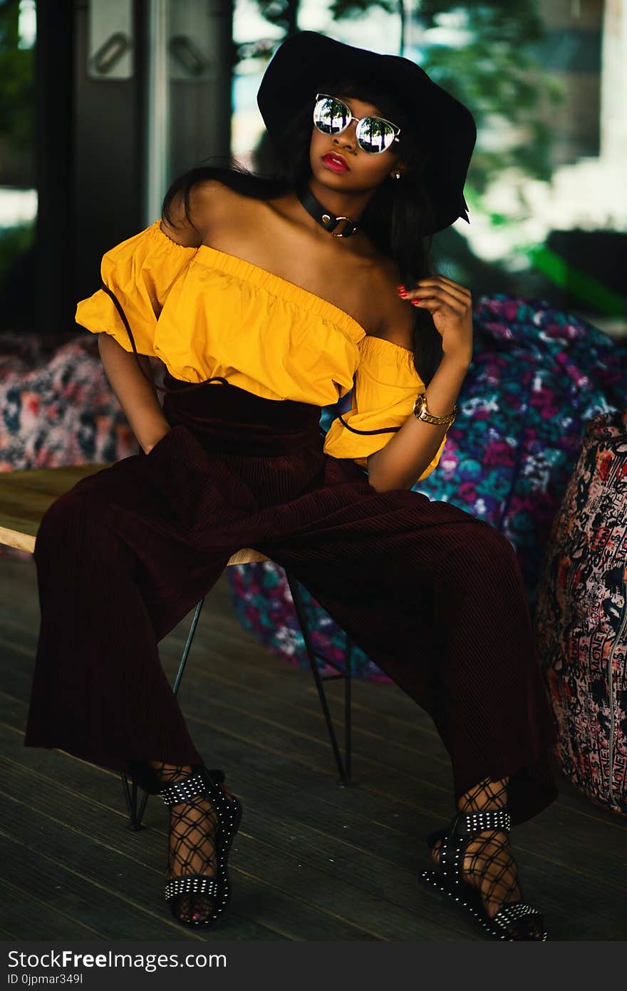 Woman in White Tube Top and Brown Pants