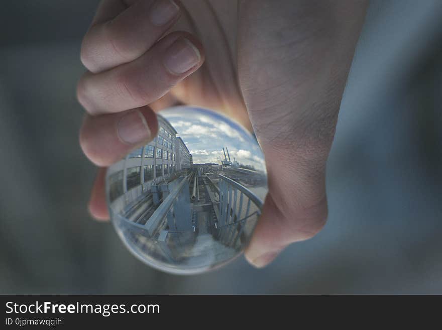 Person Holding Clear Glass Decor