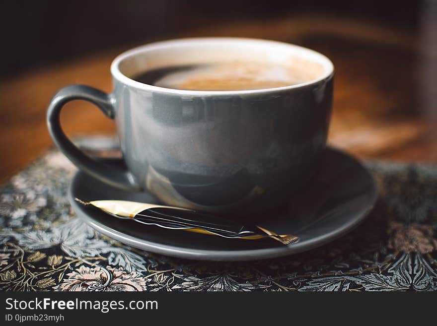 Gray Ceramic Cup of Coffee on Round Gray Saucer