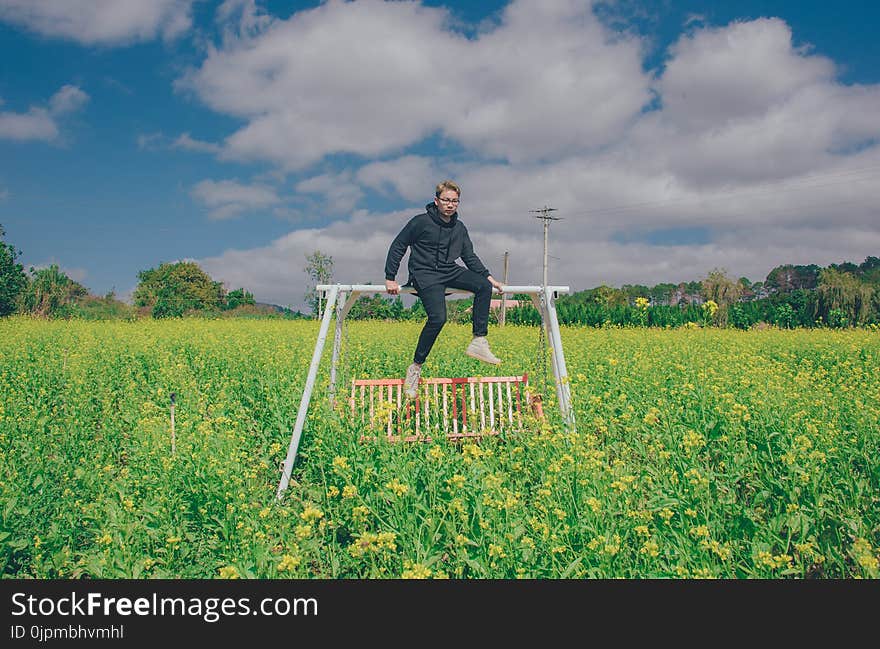 Man Sitting On White Swing