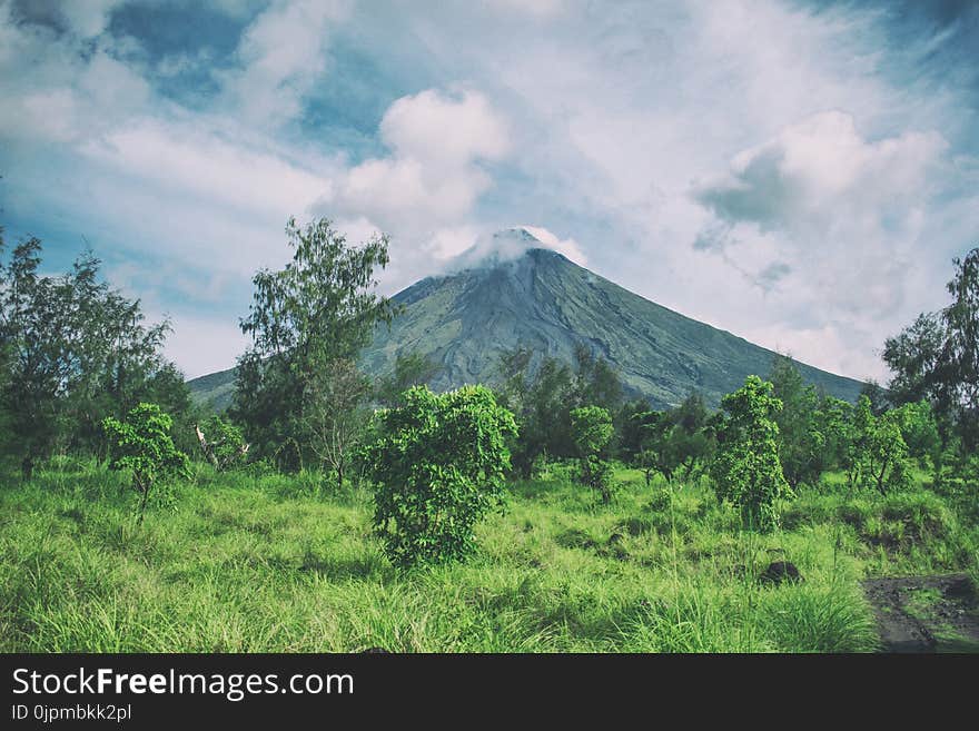 Landscape Photography Of Mountain Under Cloudy Sky