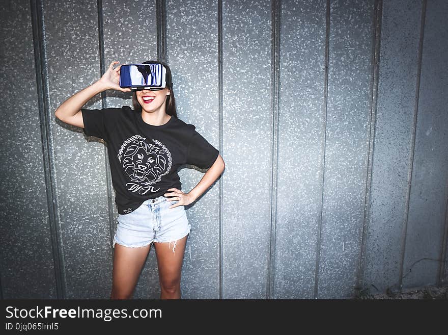 Woman in Black Crew-neck T-shirt Wearing Blue Vr Goggles