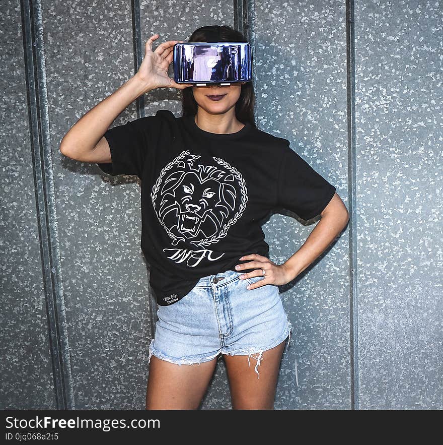 Woman Holding Virtual Reality Goggles on Her Face