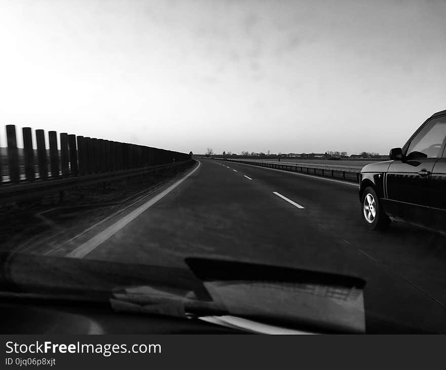 Grayscale Photography of Car on Road