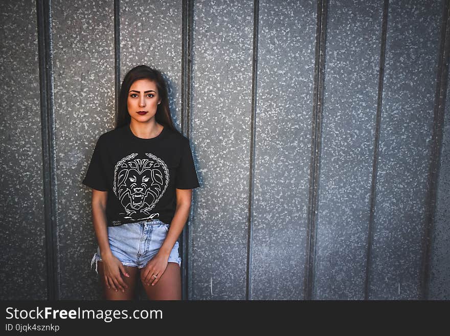 Woman Wearing Black Crew Neck Shirt and Blue Denim Shorts