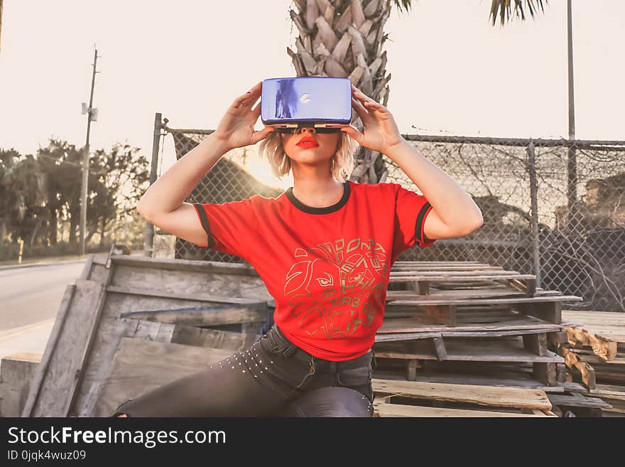 Woman in Red Crew-neck T-shirt Wearing Virtual Reality Glasses