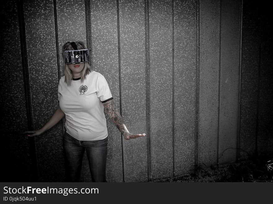 Woman Wearing Virtual Reality Headset Standing Beside Wall