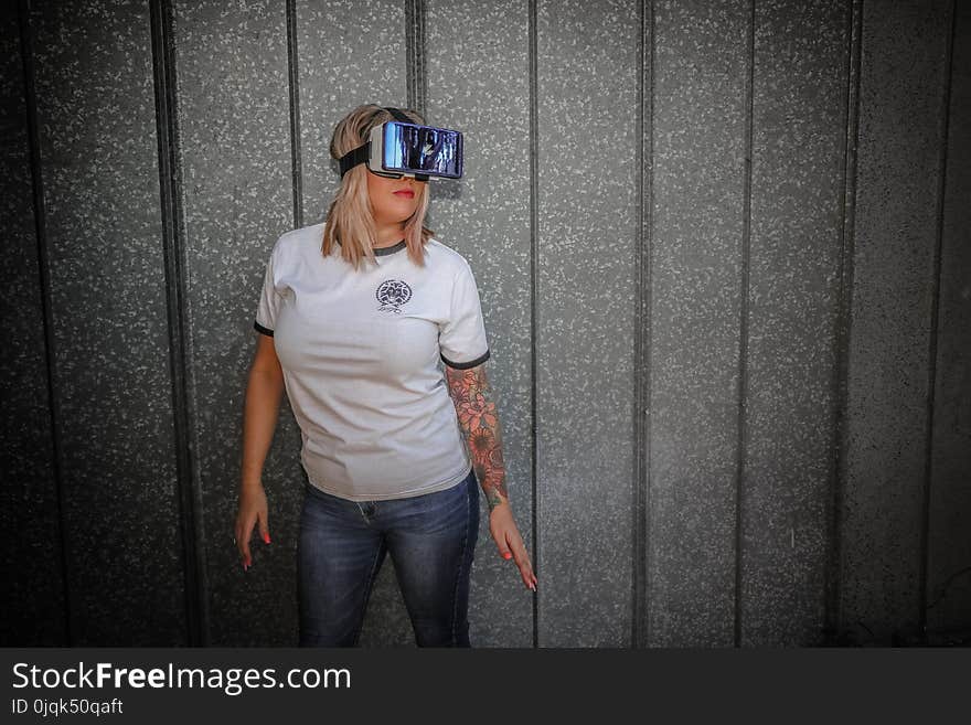 Photograph of Woman Wearing Vr Glass in Front of Wall