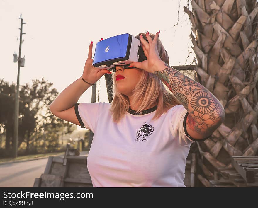 Photo of a Woman Using Virtual Reality Glasses