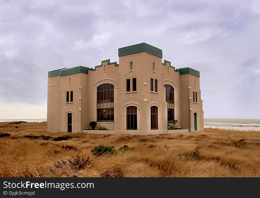 Brown Concrete Mansion at the Middle of Nowhere