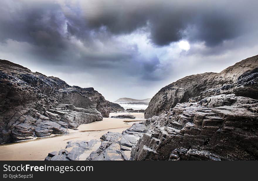 Gray Rock Formation Under Clouds at Daytime