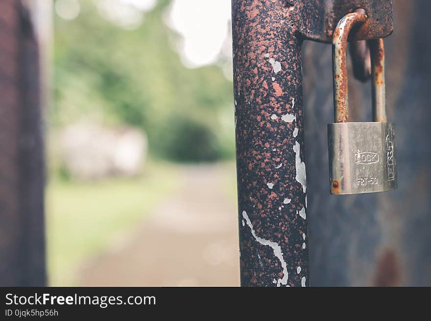 Rusted Grey Padlock in Selective-focus Photography