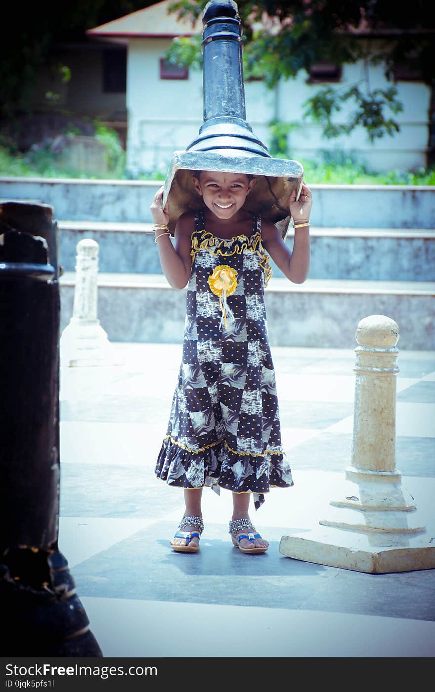 Photo of Girl Carrying Giant Chess