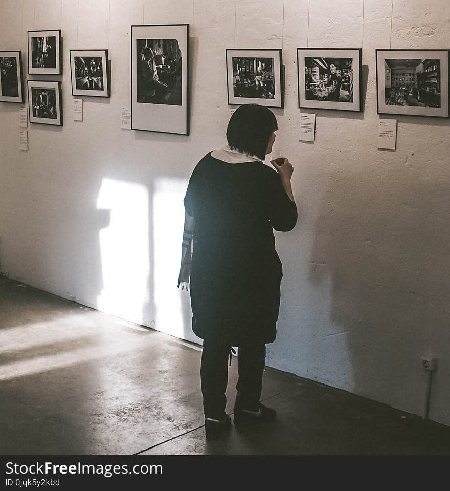 Standing Woman Looking at Photos