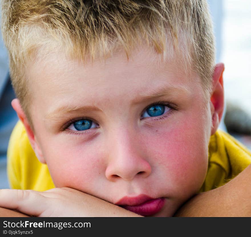 Close-Up Photography of Boy With Blue Eyes