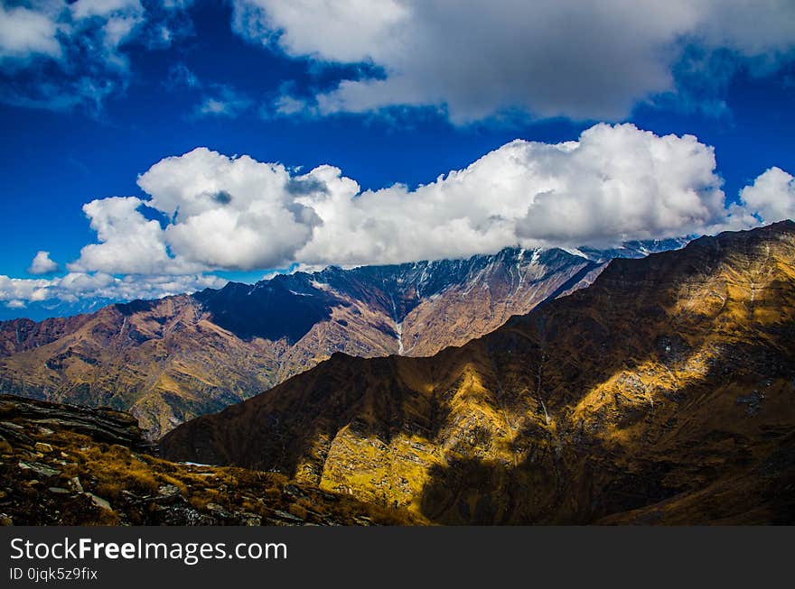 Mountains Under White Clouds