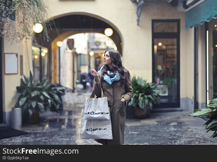 Woman in Brown Full-zip Long-sleeved Coat With Tote Bags