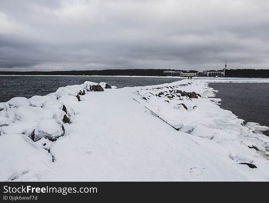 Pathway Between Body of Water Filled With Snow