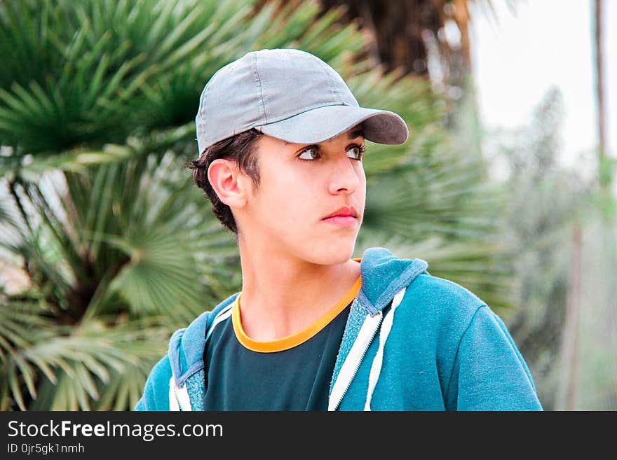 Man Wearing Gray Cap and Blue Jacket