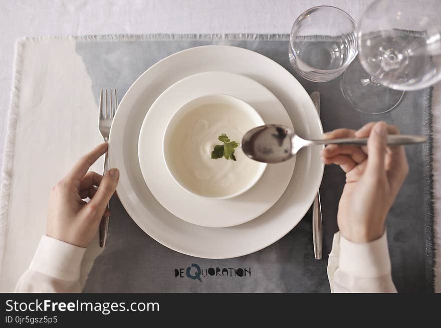 Person Wearing White Dress Shirt Holding Spoon