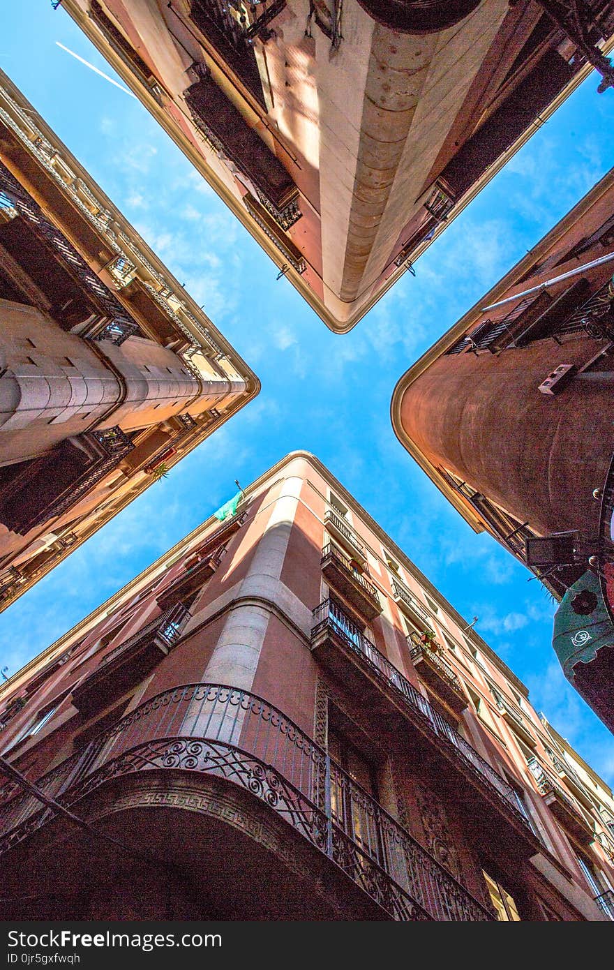 Low Angle Photo of Four Brown Concrete Buildings