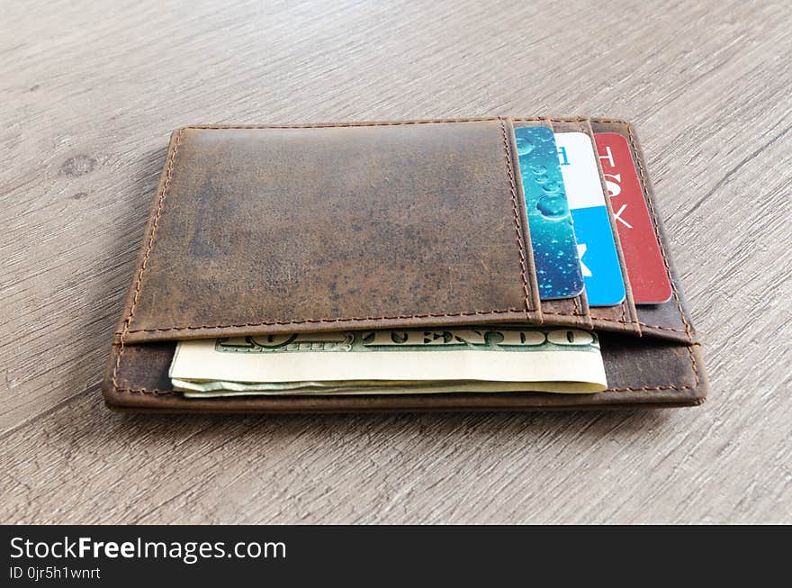 Brown Leather Wallet and Us Dollar Banknote