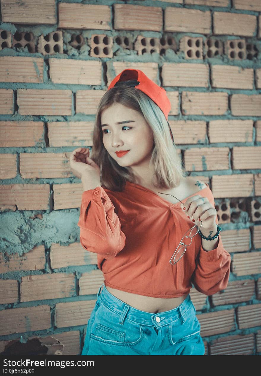 Woman in Orange Long-sleeved Shirt With Blue Denim Bottoms