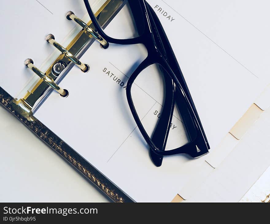 Black Framed Wayfarer Style Eyeglasses on White Surface