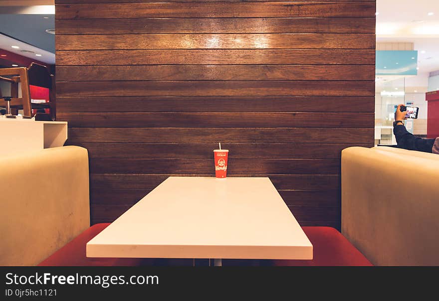 Red Disposable Cup on White Table