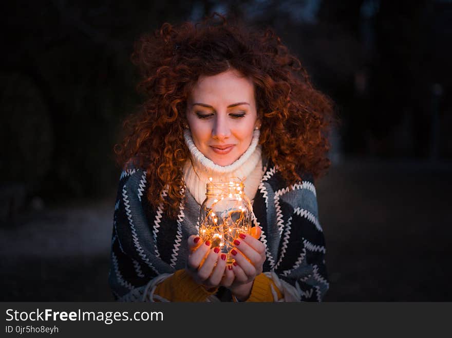 Woman Holding Clear Glass Jar Filled With Lights