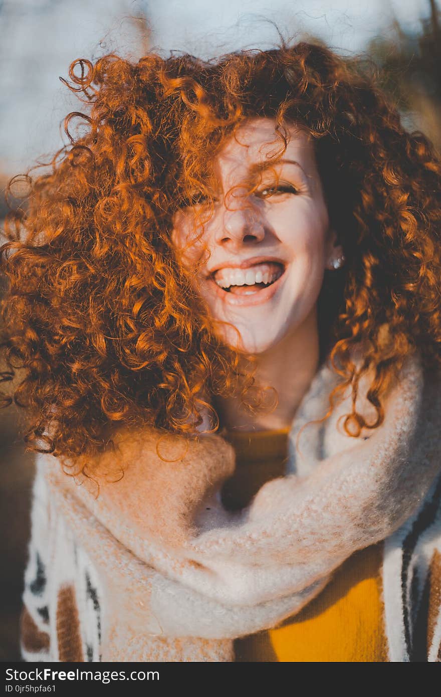 Woman Wearing Gray Knitted Scarf While Smiling