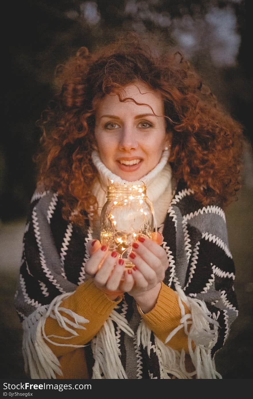 Woman Holding Clear Glass Jar With String Lights