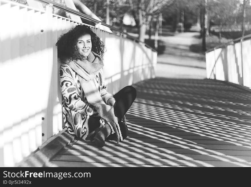 Woman Leaning Near White Metal Rail on Bridge